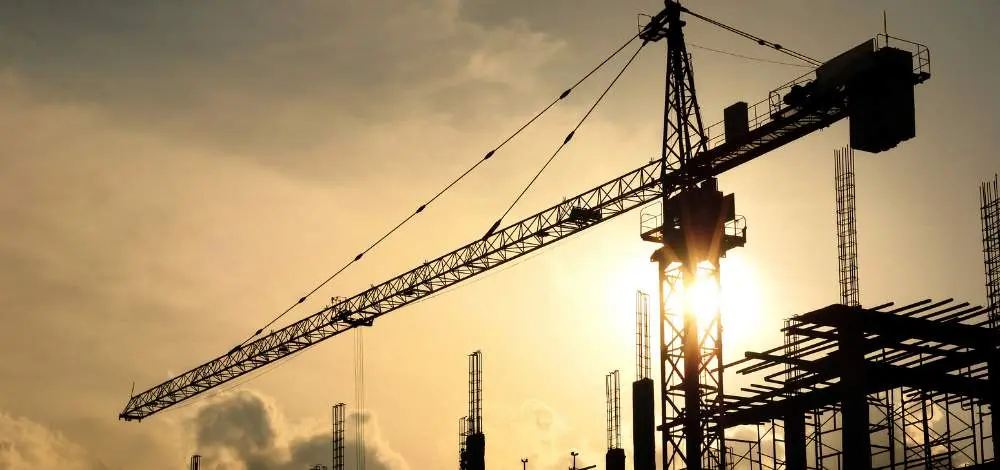 Tower crane on a building site at sunset